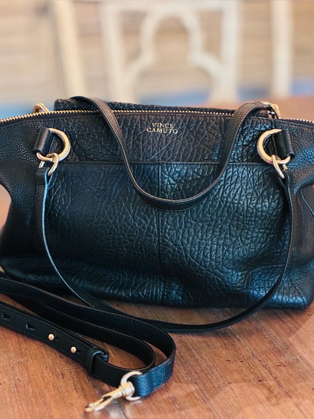 Vince Camuto black bag with gold hardware.